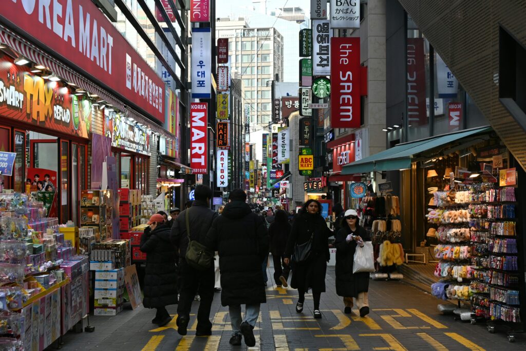 Busy Myeongdong shopping street during the day in Seoul